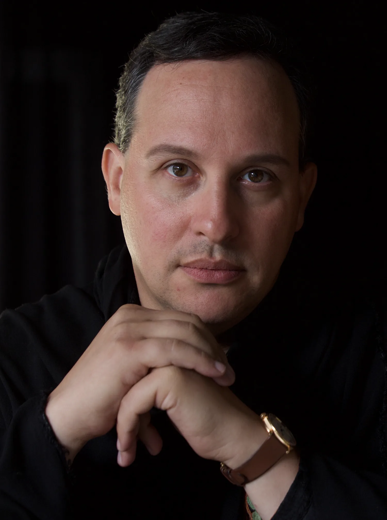 Brian Baruch, hands folded beneath his chin